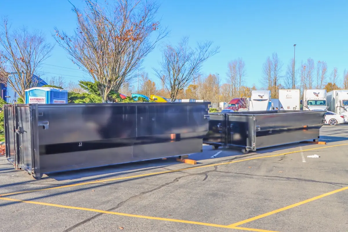 Professional dumpster rental service with roll-off container on residential driveway in New Holland